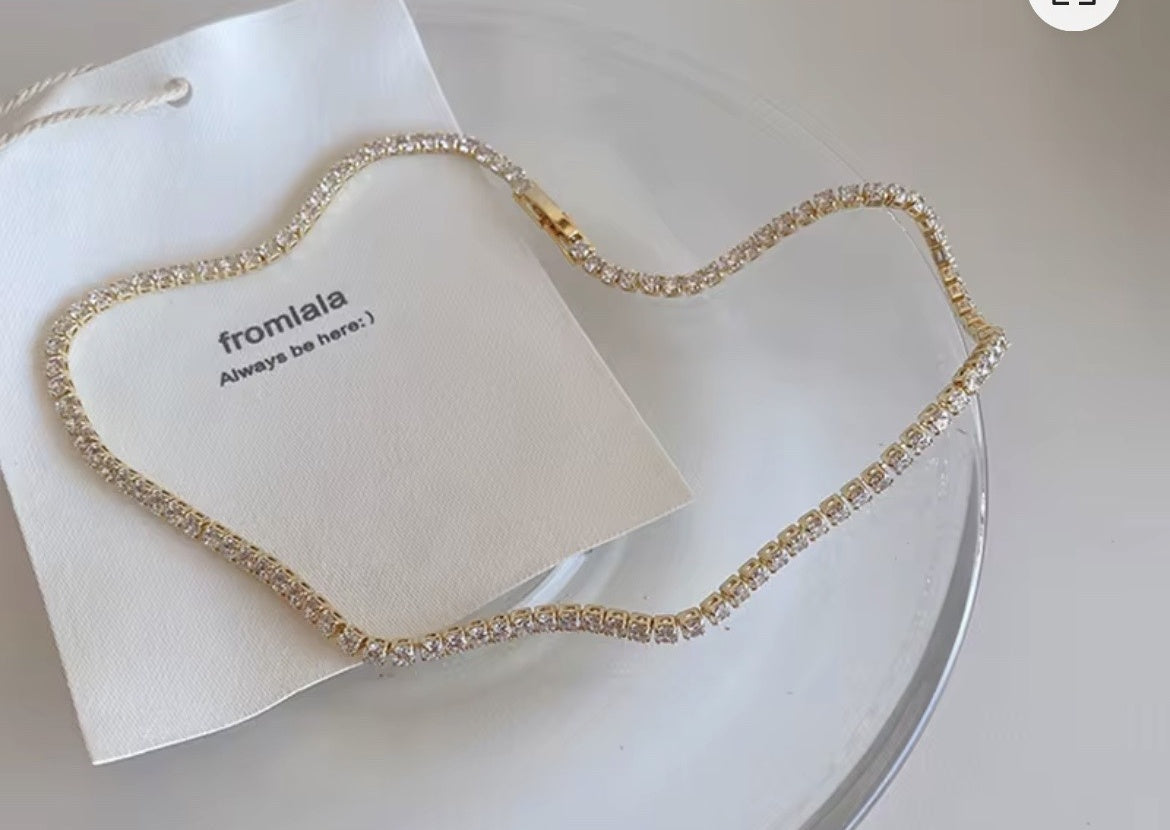 14K gold-plated rhinestone choker laid flat